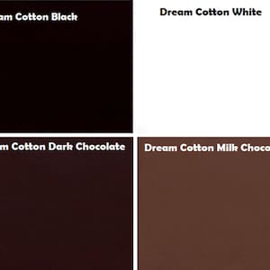 May include: A grid of four solid colour fabric swatches labelled Dream Cotton Black, Dream Cotton White, Dream Cotton Dark Chocolate, and Dream Cotton Milk Chocolate. Each square displays a distinct, uniform shade of black, white, or brown.