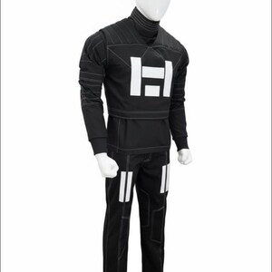 May include: A black long-sleeved shirt and matching pants set featuring a high turtleneck collar, white rectangular graphic accents on the chest and thighs, and visible white contrast stitching throughout the garment on a white mannequin.