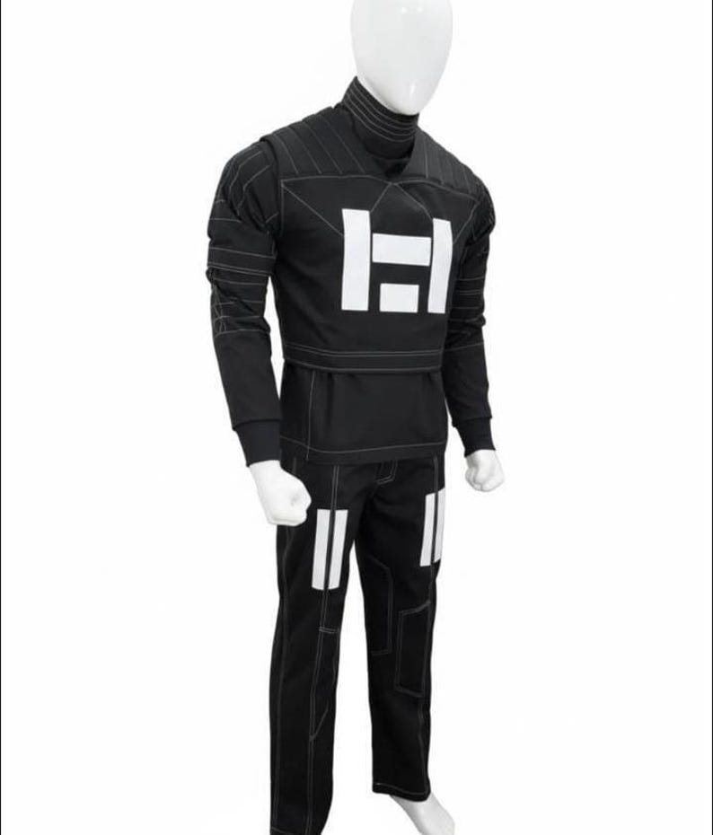 May include: A black long-sleeved shirt and matching pants set featuring a high turtleneck collar, white rectangular graphic accents on the chest and thighs, and visible white contrast stitching throughout the garment on a white mannequin.