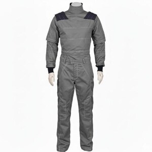 May include: A gray jumpsuit with a high collar and long sleeves. The suit has dark blue shoulder accents and white stitching details. The cuffs and collar are black. The jumpsuit is displayed on a mannequin.