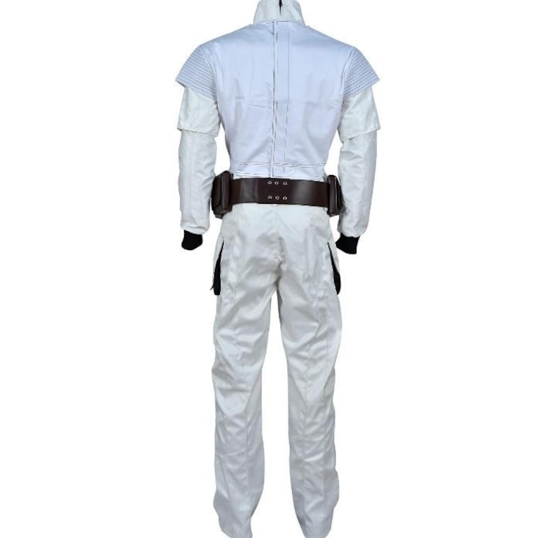 May include: A white jumpsuit with a high collar and long sleeves. The costume features a brown belt with pouches and black accents on the legs and wrists. The outfit is designed for cosplay or costume events.
