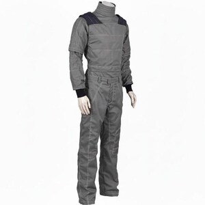 May include: A gray jumpsuit with a high collar and long sleeves. The suit has dark blue shoulder accents and white stitching details. The cuffs and collar are black. The suit is displayed on a mannequin.