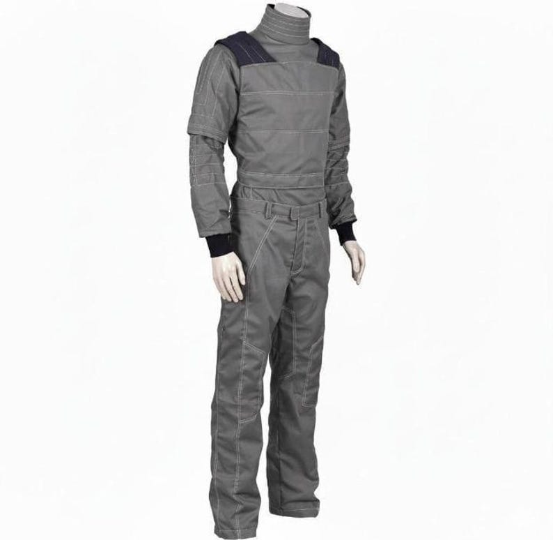 May include: A gray jumpsuit with a high collar and long sleeves. The suit has dark blue shoulder accents and white stitching details. The cuffs and collar are black. The suit is displayed on a mannequin.