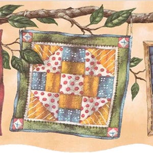 May include: A square quilt design with a patchwork pattern in shades of yellow, blue, and white with red polka dots. The quilt is framed with a green border and hangs from a tree branch with green leaves.