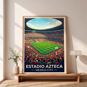 May include: A framed art print depicting the Estadio Azteca in Mexico City, featuring a high-angle view of a soccer stadium filled with spectators, a green pitch, and a bright blue sky. The text ESTADIO AZTECA MEXICO CITY is printed at the bottom.