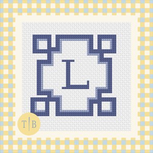 May include: A cross stitch pattern featuring a dark blue letter L centered within a geometric frame of interconnected squares. The design is set against a white grid background, surrounded by a yellow and light blue checkered border with a TB logo.