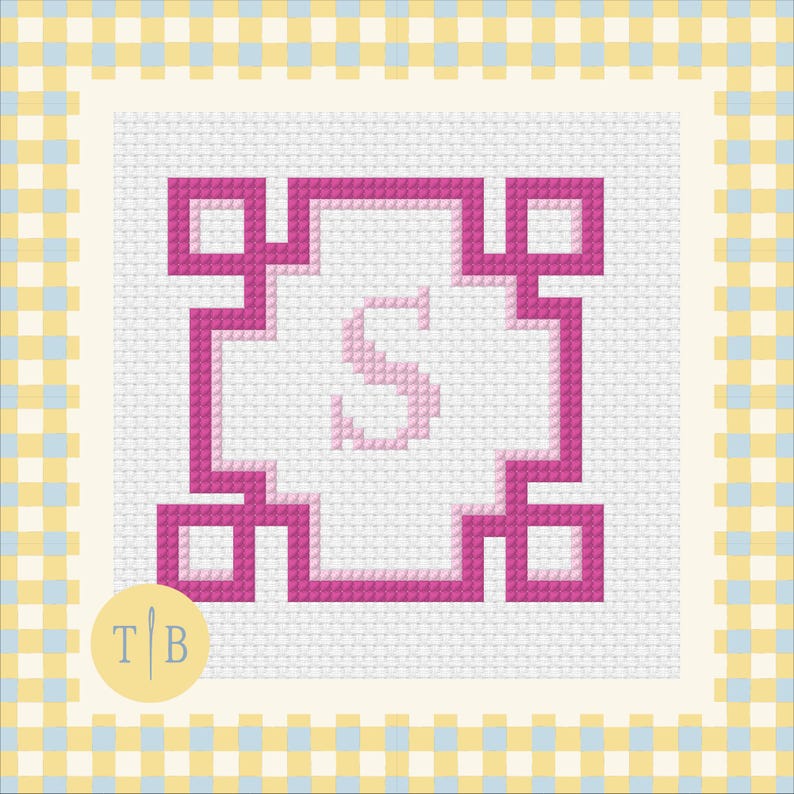 May include: A cross-stitch pattern on white Aida fabric featuring a central light pink letter S enclosed within a bold, geometric magenta border. The design is framed by a yellow and light blue checkered border, with a circular logo containing T B.
