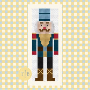 May include: A pixel art style nutcracker figure featuring a light blue hat, a dark blue jacket with red cuffs, a tan chest piece, black trousers, and brown boots. The figure has a white beard, a brown mustache, and a small red nose.