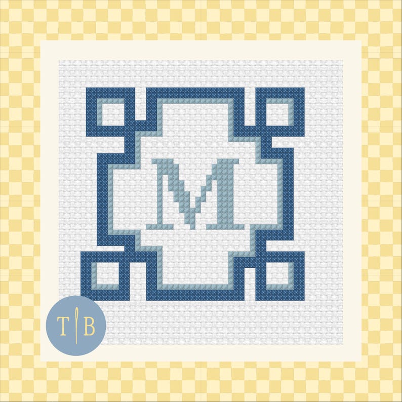 May include: A cross-stitch pattern featuring a central letter M in light blue, surrounded by a geometric border of dark blue and light blue squares. The design is stitched on a white fabric grid, creating a clean, symmetrical, and structured monogram.