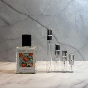 May include: A set of three ceramic mugs with a speckled, matte finish in cream, light grey, and dark grey. Each mug has a simple, modern design and a rounded handle.