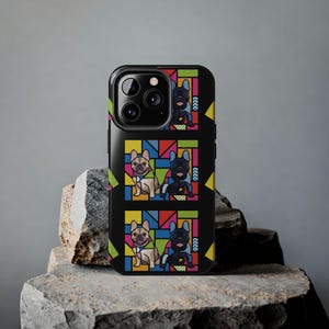 May include: Black phone case featuring a repeating pattern of French Bulldogs in a colorful, geometric design. The dogs are depicted in tan and black, with a vibrant background of red, blue, yellow, and green.