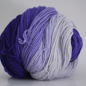 May include: A ball of yarn with a gradient of purple, lavender, and white.