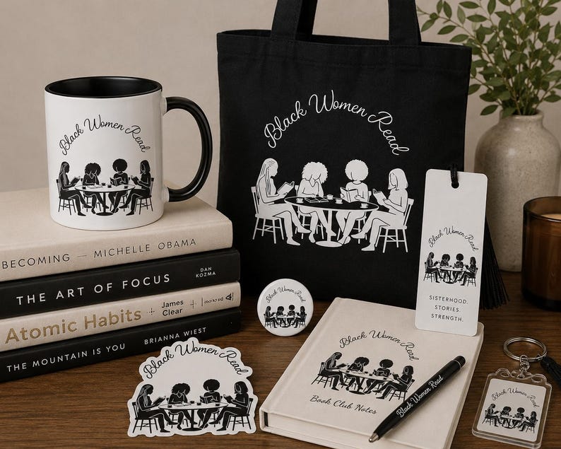 May include: A collection of items featuring the text Black Women Read and a graphic of four people at a table, including a white mug with a black handle, a black tote bag, a white bookmark, a notebook, a pen, a circular pin, a sticker, and a keychain.