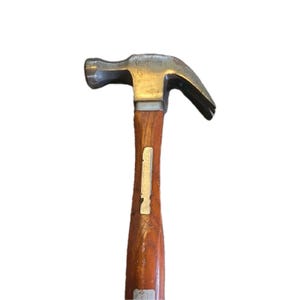 May include: A Craftsman claw hammer with a wooden handle. The hammerhead is silver and the handle is a warm brown color. The hammer is designed for driving nails and other construction tasks.