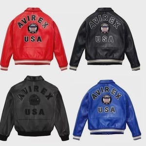 May include: Four leather bomber jackets in red, black, and blue. Each jacket features the "AVIREX" logo and "USA" text on the back, with a striped hem and cuffs. The jackets are a classic style.