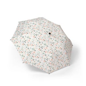 May include: A floral print umbrella with a white background, featuring a pattern of pink and green flowers and leaves. The umbrella is open, showcasing its full design. The handle is not visible.
