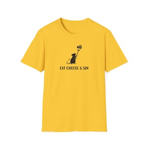May include: Mustard yellow t-shirt featuring a black graphic of a rat holding a pitchfork with cheese, and the text "EAT CHEESE & SIN". The shirt is made of a soft material and has a crew neck.