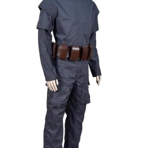 May include: A dark blue costume with a high collar, shoulder pads, and long sleeves. The outfit includes matching pants and a brown belt with multiple pouches. The costume is displayed on a mannequin against a white background.