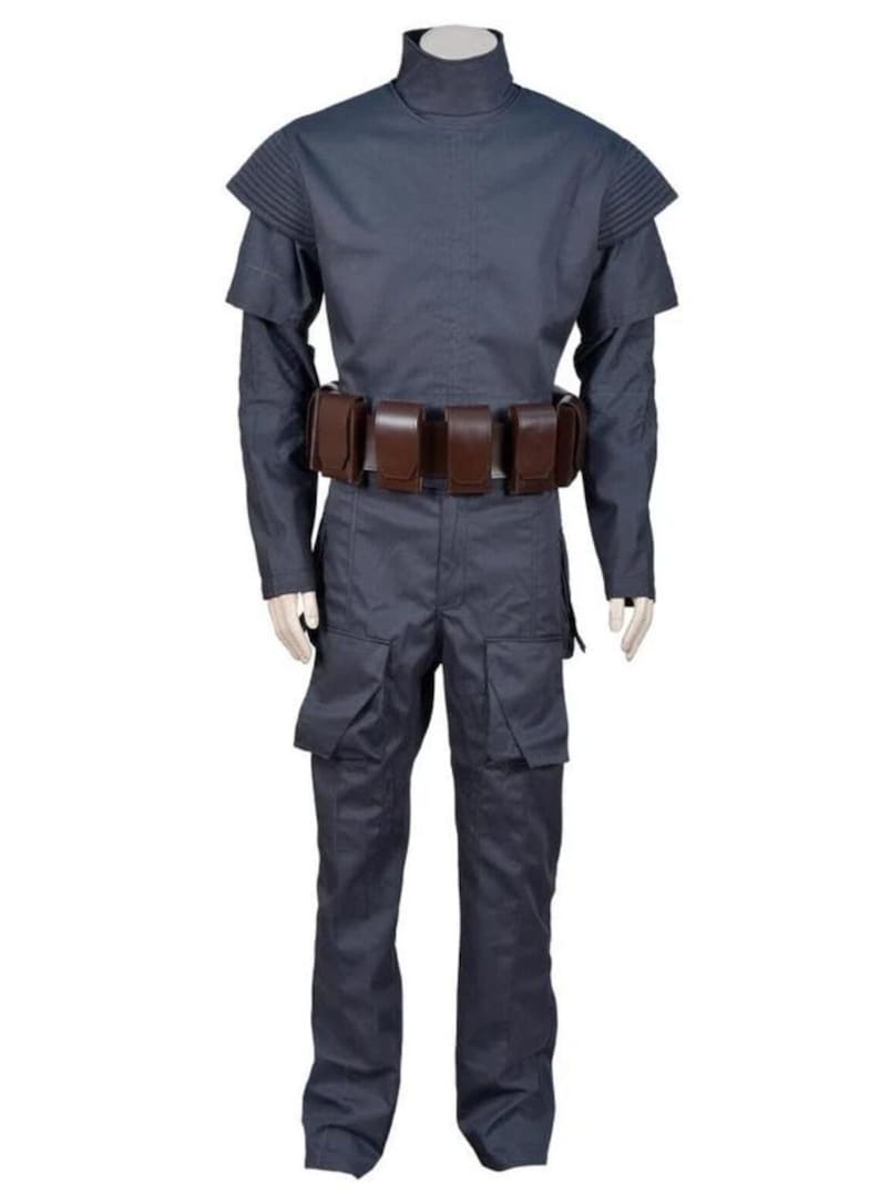 May include: A dark blue costume with a high collar, shoulder accents, and long sleeves. The outfit includes matching trousers with cargo pockets and a brown belt with pouches. The costume is displayed on a mannequin.