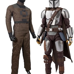 May include: Two action figures of characters from a science fiction franchise. One figure is dressed in brown and black clothing. The other figure is wearing silver armor, a helmet, and brown clothing, with a blaster pistol.