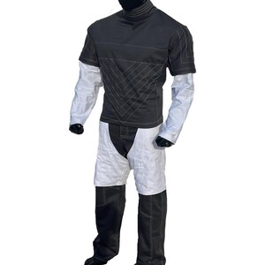 May include: A handmade wooden sign with the text "Welcome" in a playful font. The sign is painted white with a distressed finish, and features a decorative floral design in shades of pink and green. It measures approximately 12 inches wide.