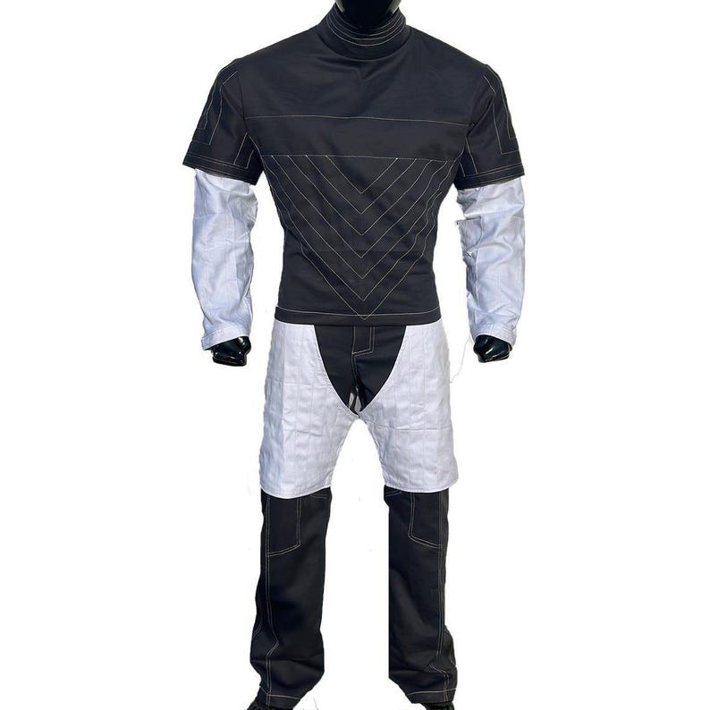 May include: A white ceramic mug with a black handle and the text "But First, Coffee" in a black, bold font. The mug is likely 10 cm tall and holds approximately 350 ml of liquid.