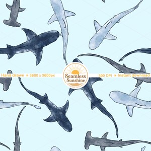 May include: A seamless pattern featuring various watercolor shark illustrations in shades of blue and gray on a light blue background. The design includes hammerhead sharks and other shark species. The image includes the text "Hand drawn", "Seamless Sunshine", and "300 DPI".
