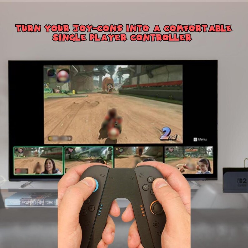 May include: A person holding a black controller with blue and orange accents, playing a video game on a large screen. The text "TURN YOUR JOY-CONS INTO A COMFORTABLE SINGLE PLAYER CONTROLLER" is displayed above the screen.