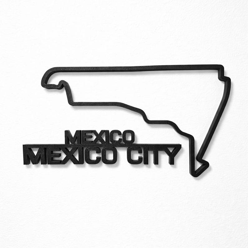 May include: A black wall-mounted sign featuring the outline of a geographic region. Below the outline, the text reads MEXICO in a smaller font size, followed by the text MEXICO CITY in a larger font size. The entire piece is solid black.