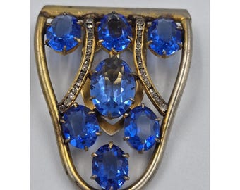 Pinza para vestido estilo Art Déco antiguo con diamantes de imitación azules y cristal tono dorado.