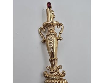 Broche para candelabro Coro tono dorado con forma de vela, rojo y transparente, patente pendiente de 1948.