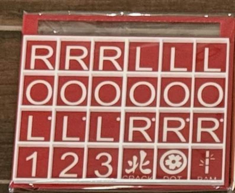 May include: A red and white tile set with letters, numbers, and symbols. The tiles spell out "RRR LLL OOOOO LLL RRR 123". Additional symbols and text are visible at the bottom of the set.