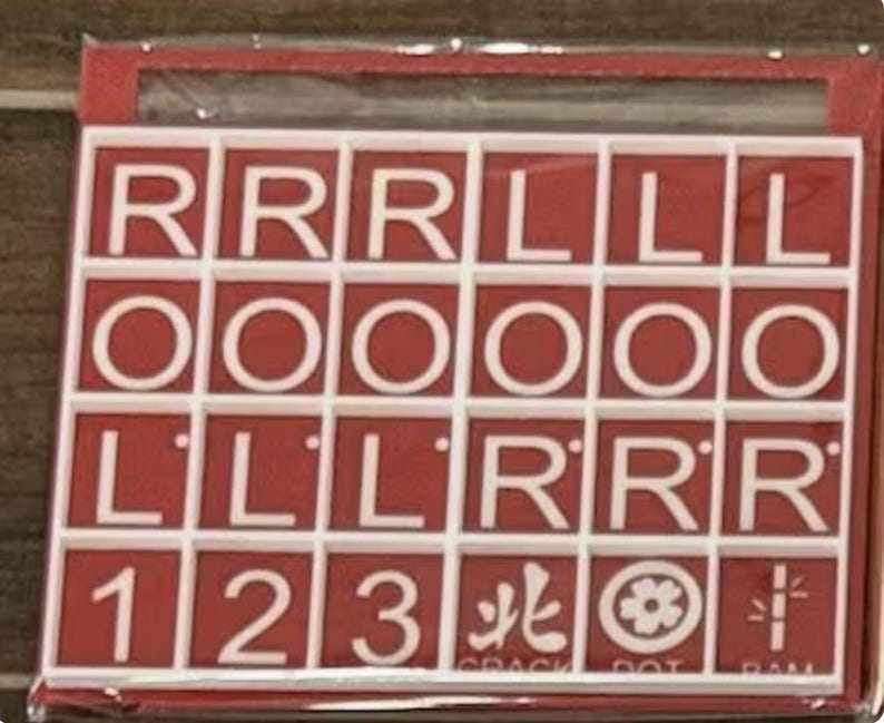 May include: A red and white tile set with letters, numbers, and symbols. The tiles are arranged in a grid, with the letters "R", "O", and "L" prominently displayed. Numbers 1, 2, and 3 are also present, along with Chinese characters and symbols.