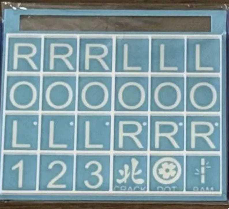 May include: A light blue Scrabble tile set with white letters and numbers. The tiles spell out words and include the numbers 1, 2, and 3. The bottom row includes the words "CRACK", "DOT", and "DAM".
