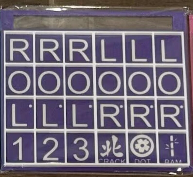 May include: A purple and white word game board with letter tiles. The tiles spell out words and include numbers and symbols. The bottom row has the words CRACK, DOT, and RAM.