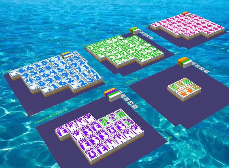 May include: An overhead view of a digital board game set against a blue water background. The game features multiple rectangular platforms with colorful tiles displaying numbers, letters, and symbols. Each platform has a different tile design.