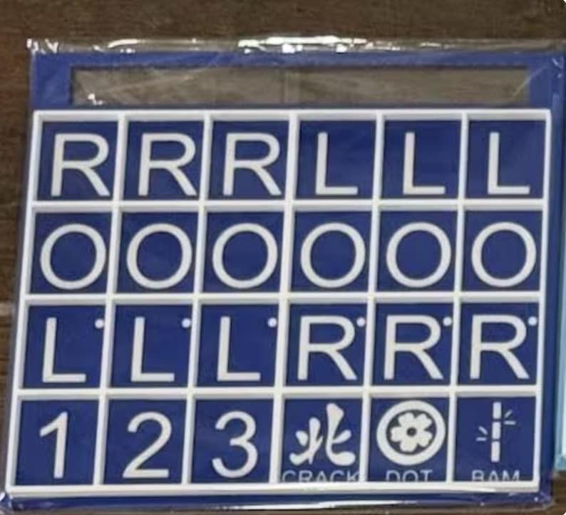 May include: A blue and white tile game board with letters and numbers. The board has white squares with the letters R, L, and O, and the numbers 1, 2, and 3. The board also has symbols and the words CRACK, DOT, and RAM.