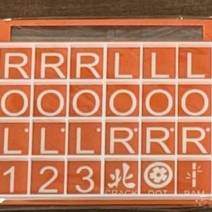 May include: An orange game board with white letter tiles spelling out "RRRLL OOOOO LLLRR 123". The game board also includes symbols and the text "CRACK DOT RAM".