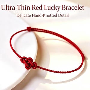 May include: An ultra-thin red cord bracelet featuring a delicate hand-knotted detail. The text Ultra-Thin Red Lucky Bracelet and Delicate Hand-Knotted Detail is visible above the bracelet, which is formed from a single continuous red string.