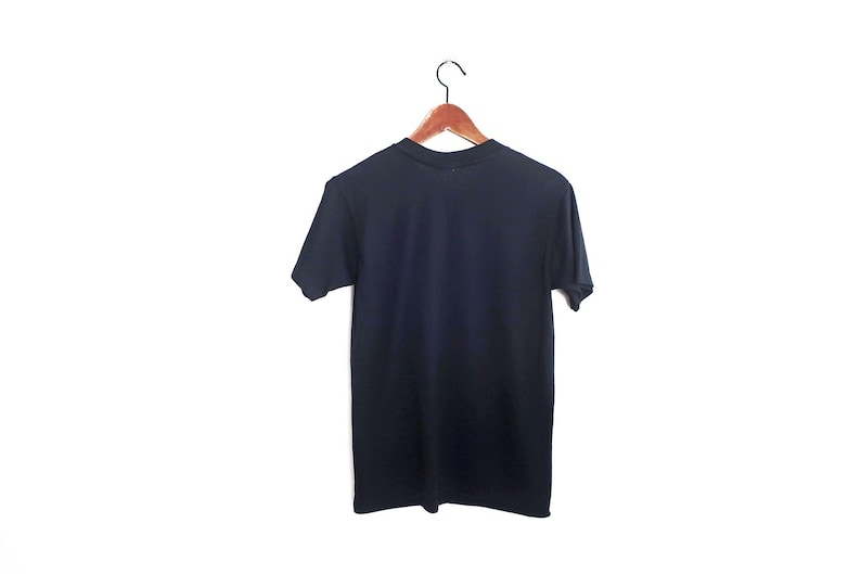 May include: A plain dark blue t-shirt hanging on a wooden hanger against a white background.