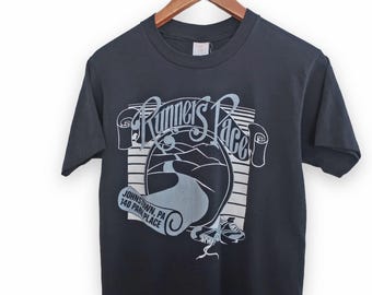 May include: Black t-shirt with a white graphic of a road winding through a landscape with the text "Runner's Pace" and "Johnstown, PA 140 Park Place".
