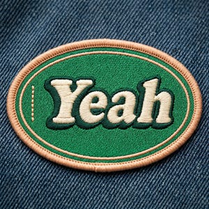 May include: An oval-shaped embroidered patch featuring the word Yeah in cream-colored, bold, serif-style lettering. The text has a dark green shadow effect and is centered on a vibrant green background, all enclosed by a light tan stitched border.