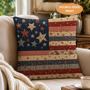 May include: A decorative square pillow with a quilted American flag design. The pillow features a navy blue field with stars and red and white stripes. The pillow is double-sided.