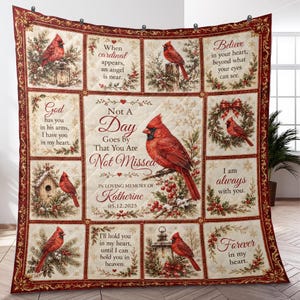 May include: A quilted throw blanket featuring red cardinal birds, holly berries, and winter greenery. The center panel displays the text "Not A Day Goes by That You Are Not Missed" with "IN LOVING MEMORY OF Katherine" and the date "05.12.2025".