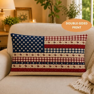 May include: Rectangular decorative pillow with a patchwork design resembling the American flag. The pillow features a blue field with white stars, red and white stripes, and floral and gingham patterns. The text "DOUBLE-SIDED PRINT" is visible.