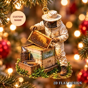 May include: A flat, hanging ornament featuring a beekeeper in a white protective suit and veil, holding a honeycomb frame over a wooden beehive. The hive is labeled with the name David and includes a metal smoker and brush tool.
