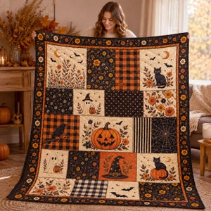 May include: A rectangular patchwork quilt featuring Halloween-themed motifs including a jack-o'-lantern, black cats, ghosts, bats, a witch hat, and spiderwebs. The design incorporates orange, black, and cream colors with floral and plaid patterns.