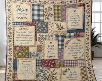 May include: A patchwork quilt featuring floral, plaid, and gingham fabric squares in blue, green, and burgundy. Several squares contain printed religious text including Jesus loves you, Proverbs 3:5, Philippians 4:13, Jeremiah 29:11, Psalm 28:7, Joshua 1:9, and Psalm 46:10.