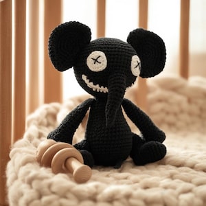 May include: A set of three ceramic mugs with a speckled, cream-colored glaze. Each mug features a different hand-painted design: a blue and green leaf, a yellow flower, and a red berry. The mugs have a simple, rounded shape.