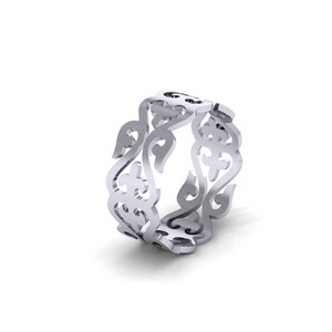 May include: A silver-toned metal ring featuring an intricate, openwork filigree design. The band is composed of repeating, symmetrical scroll and leaf-like patterns that create a continuous, airy structure around the entire circumference of the ring.